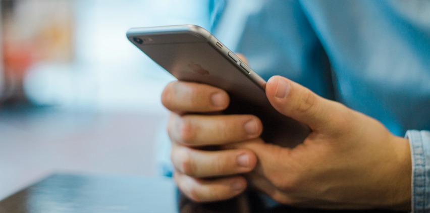 man checking email on phone freelancing