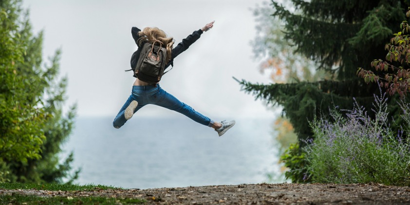 happy woman jumping after good night's sleep