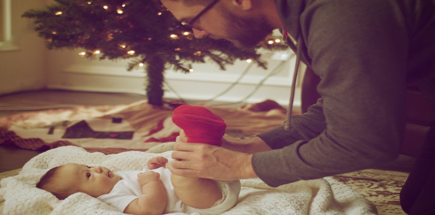 dad playing with baby christmas