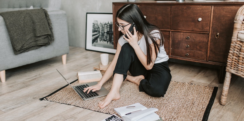 A woman conducting freelance research on her laptop