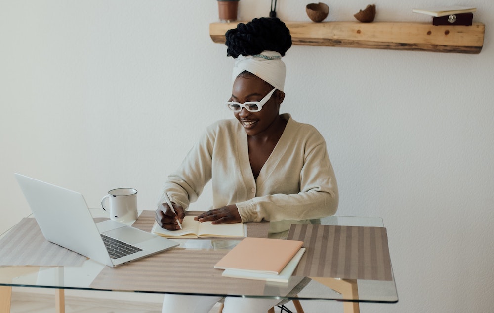 A woman working at a desk with a computer