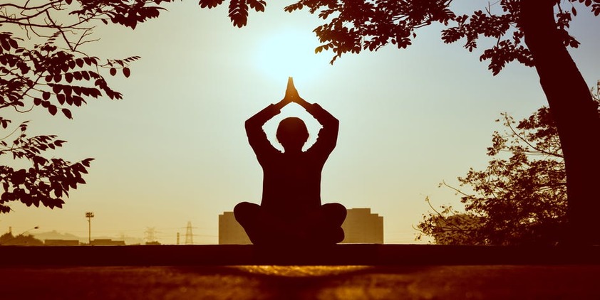 Pexels. Woman meditating at sunset