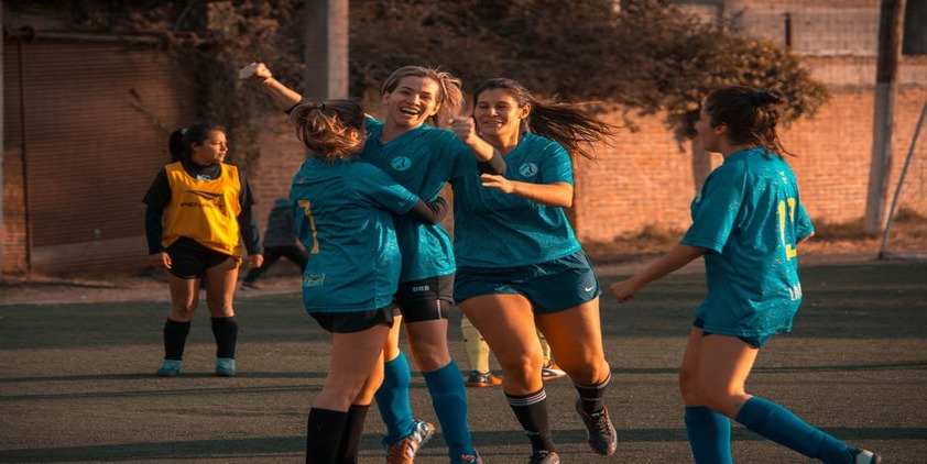 Female soccer teen athletes celebrating