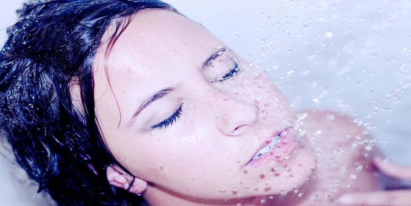 Pexels. Brunette woman washing her face