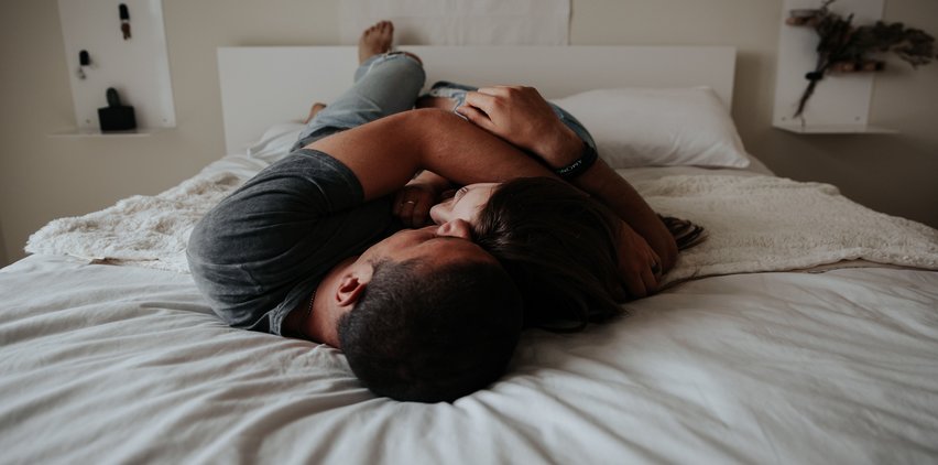 couple cuddling in bed sleeping