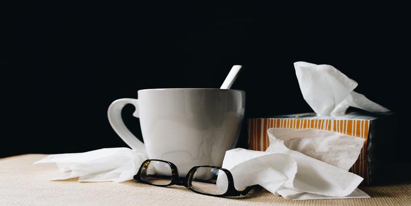 Unsplash white coffee mug and spoon, orange tissue box, and glasses on table