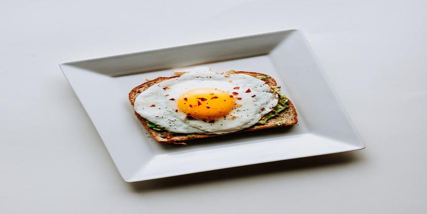 Unsplash. whole wheat toast with avocado and an egg.