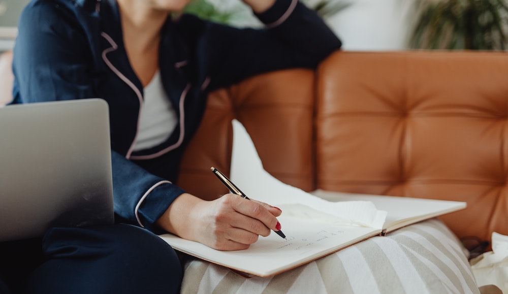 A woman writing in a notebook