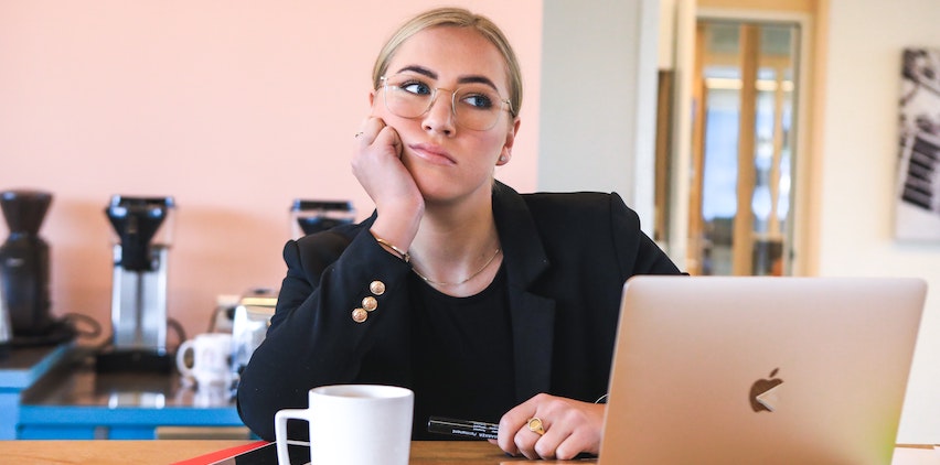 A woman procrastinating at a computer