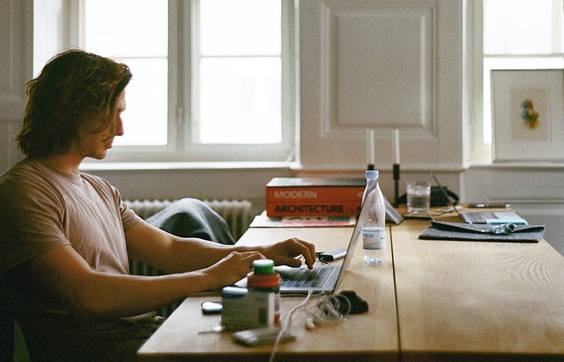 man sitting at laptop computer freelancing