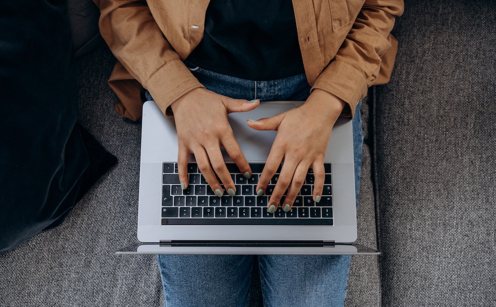 A person typing on a laptop