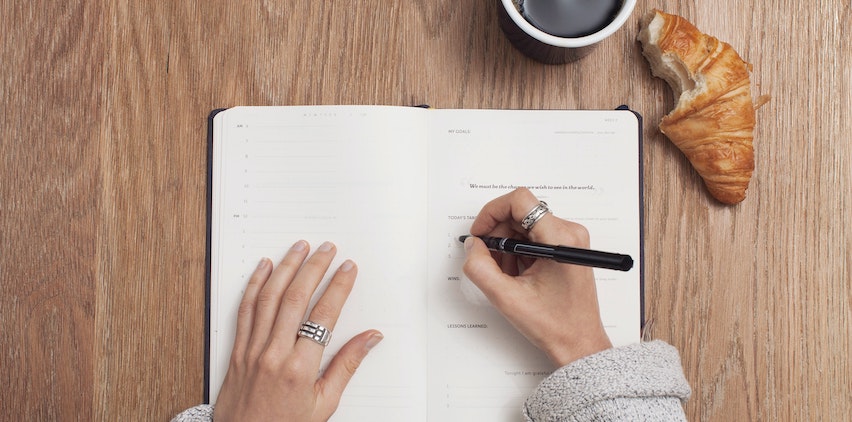 A woman writing in her planner