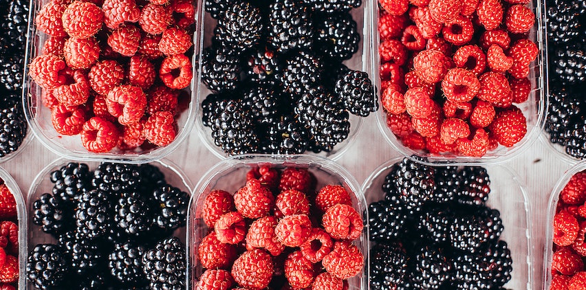 Baskets fo raspberries and blackberries.