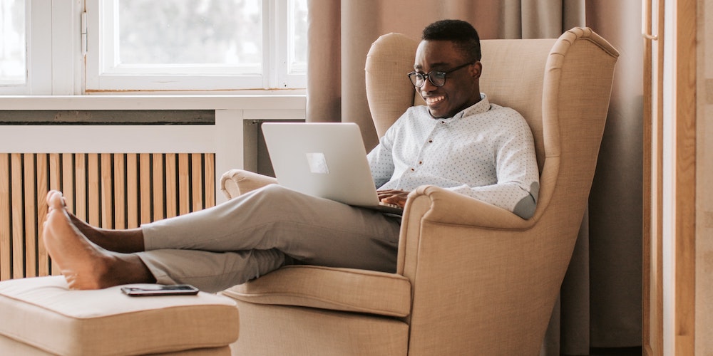 A man working on a laptop in his living room