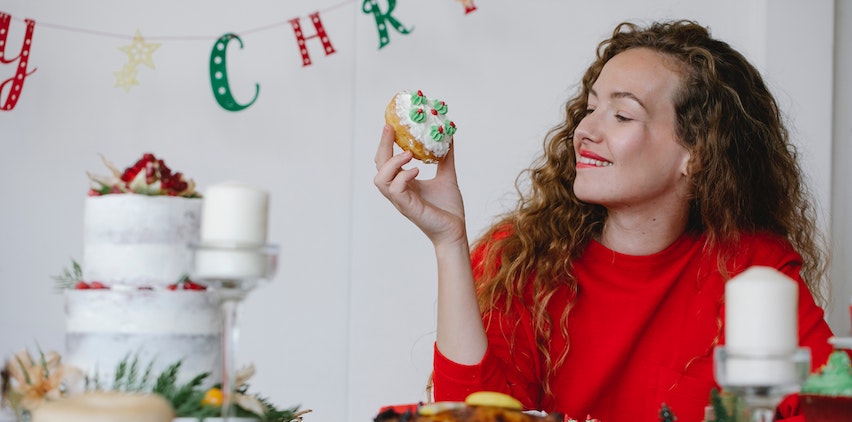 A woman holding a holiday treat