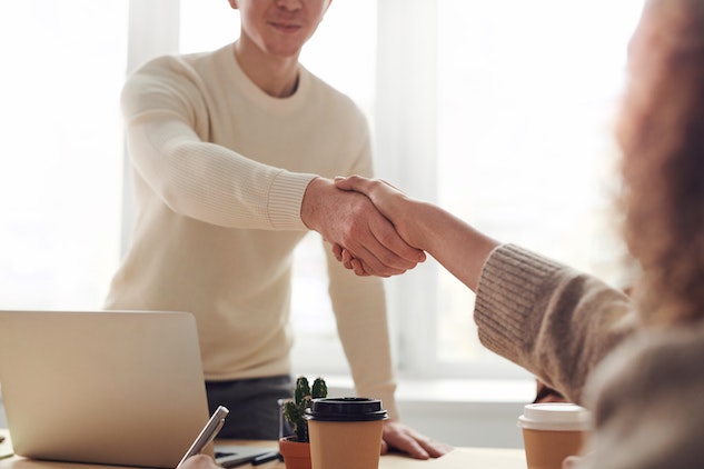 man and woman negotiation handshake