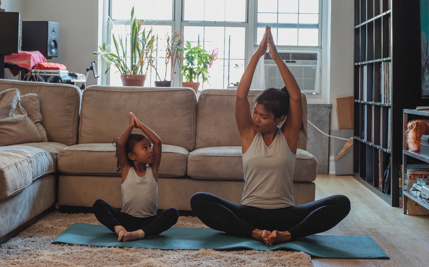 A mom doing yoga with her child