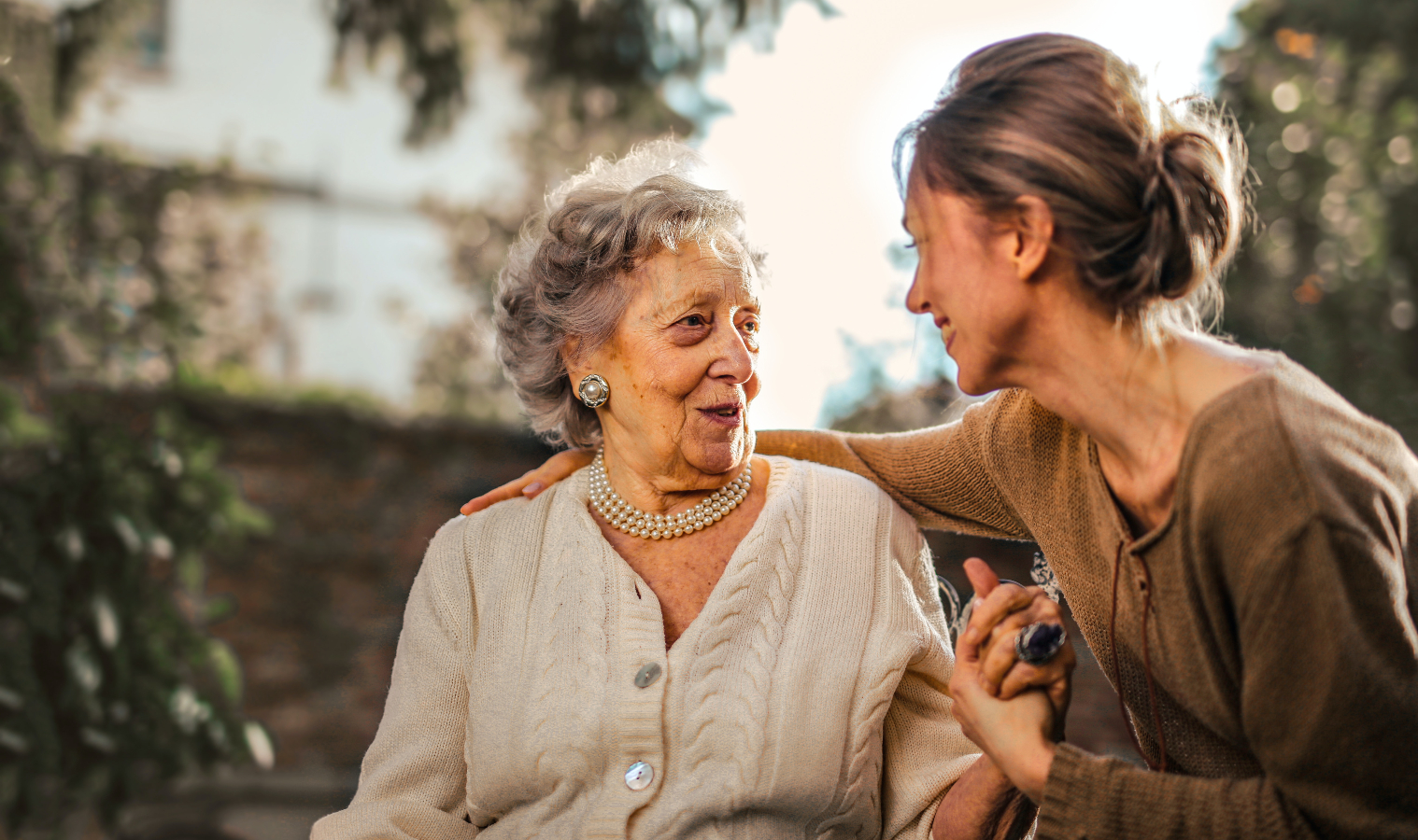 A woman chatting with an elderly woman