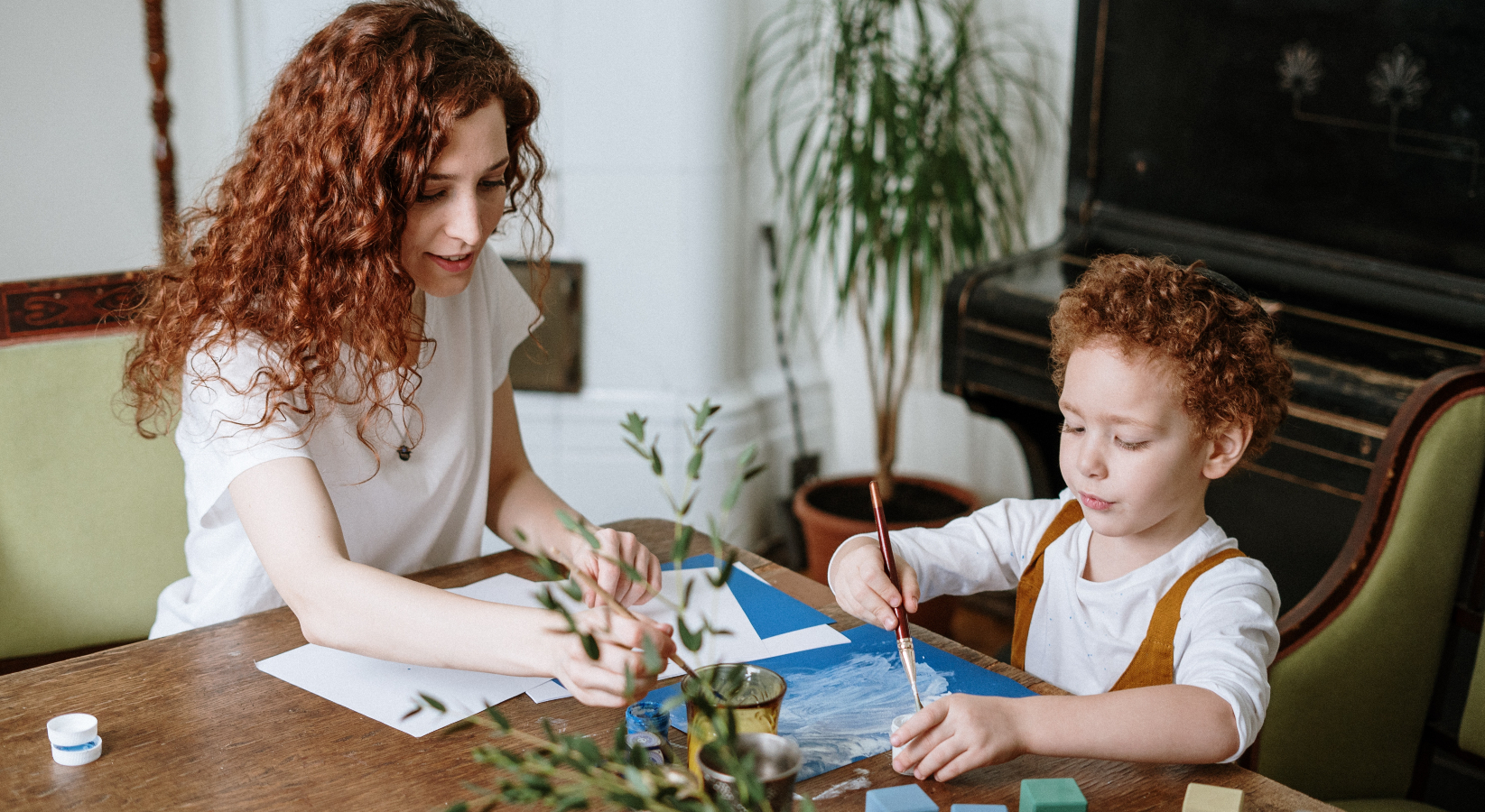 A woman painting with her child