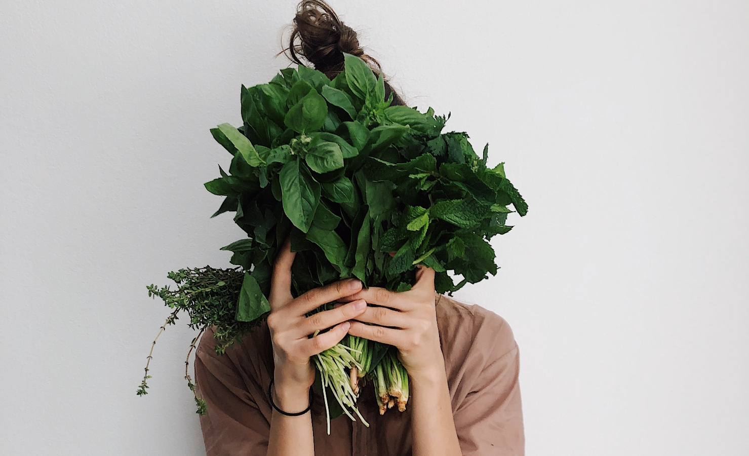 A woman holding leafy greens