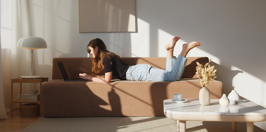 woman on couch typing