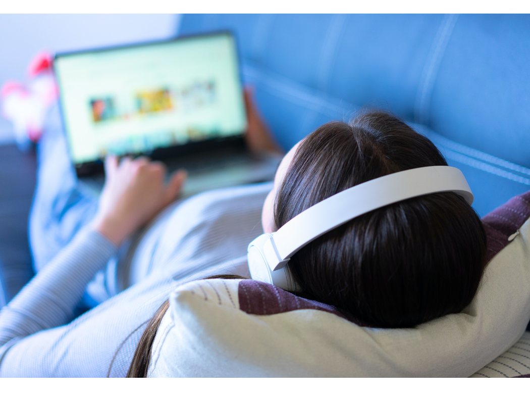 woman typing on laptop on. couch